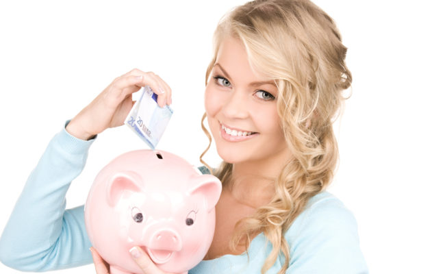 Lovely woman with piggy bank and money